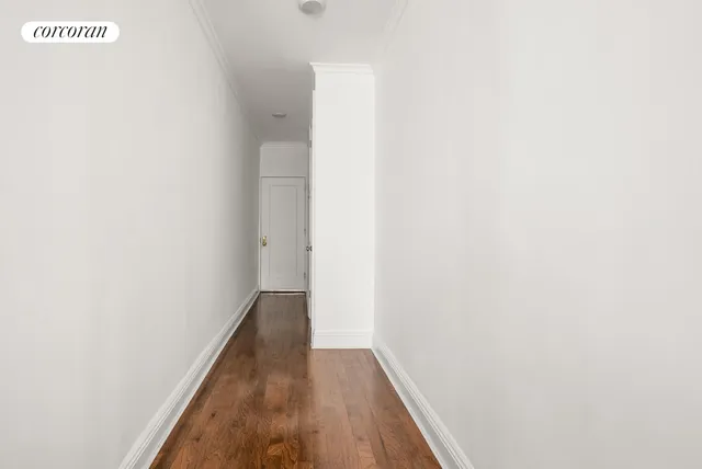a view of hallway with wooden floor
