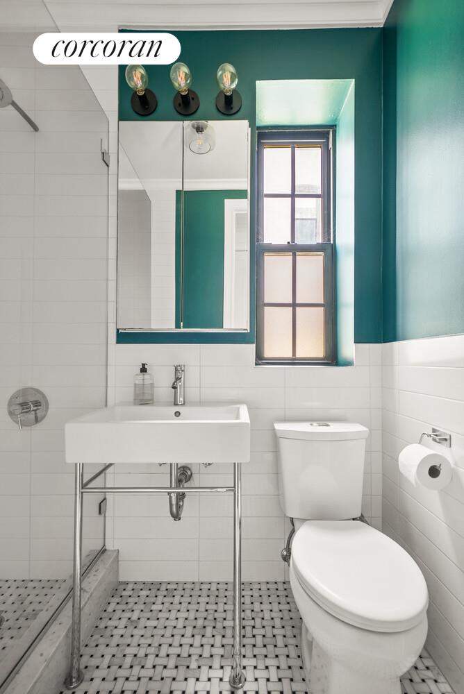 24-51 38th Street, Unit B7 Queens, NY 11103 - Photo 6 of 13 a bathroom with a toilet sink and mirror