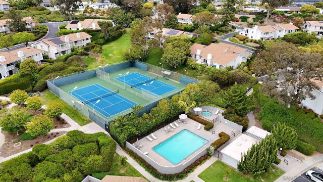 an aerial view of a residential houses with yard