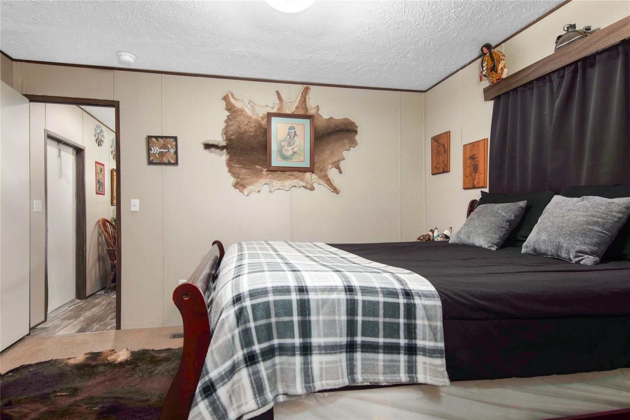 18093 Pickering Road Conroe, TX 77302 - Photo 20 of 29 a bedroom with a bed and wooden floor