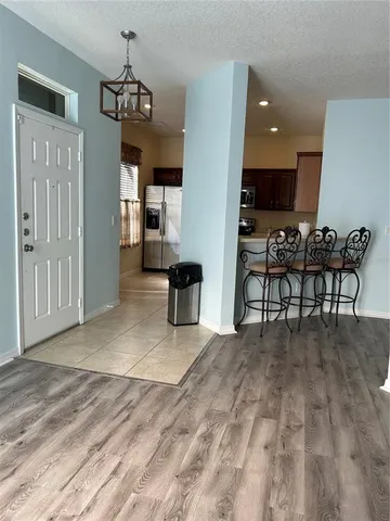 a view of a livingroom with furniture furniture wooden floor and a chandelier