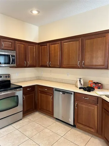 a kitchen with cabinets a sink and a stove top oven