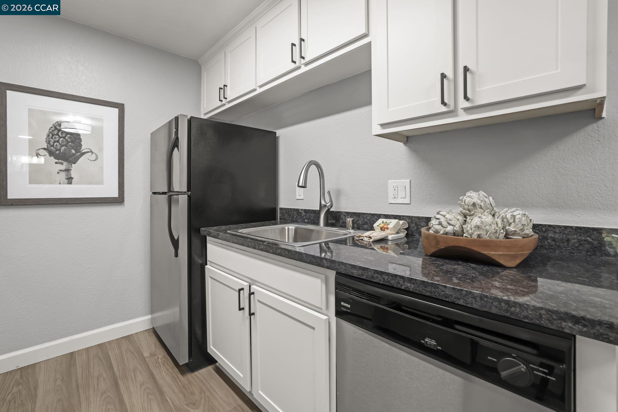 1505 Kirker Pass Road, Unit 164 Concord, CA 94521 - Photo 25 of 29 a kitchen with stainless steel appliances granite countertop a sink and a stove