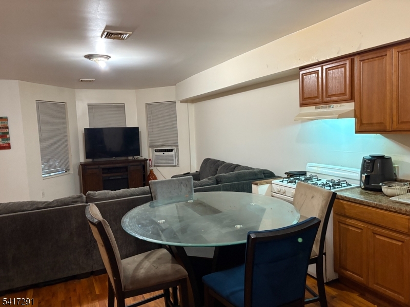 112 4th Avenue Paterson, NJ 07524 - Photo 11 of 20 a kitchen with a table and chairs in it