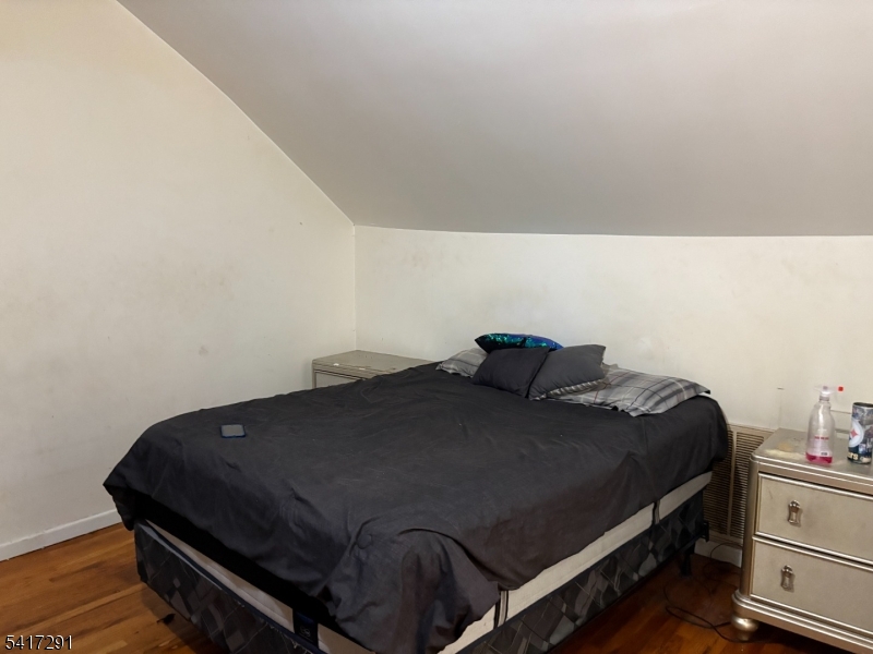 112 4th Avenue Paterson, NJ 07524 - Photo 15 of 20 a bedroom with a bed and cabinets