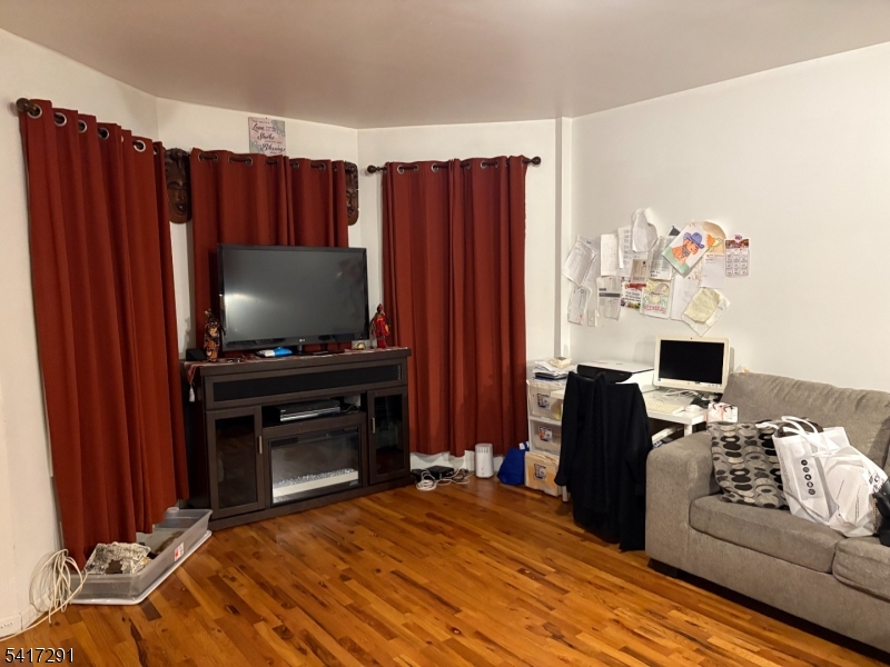 112 4th Avenue Paterson, NJ 07524 - Photo 3 of 20 a bedroom with a bed and a television
