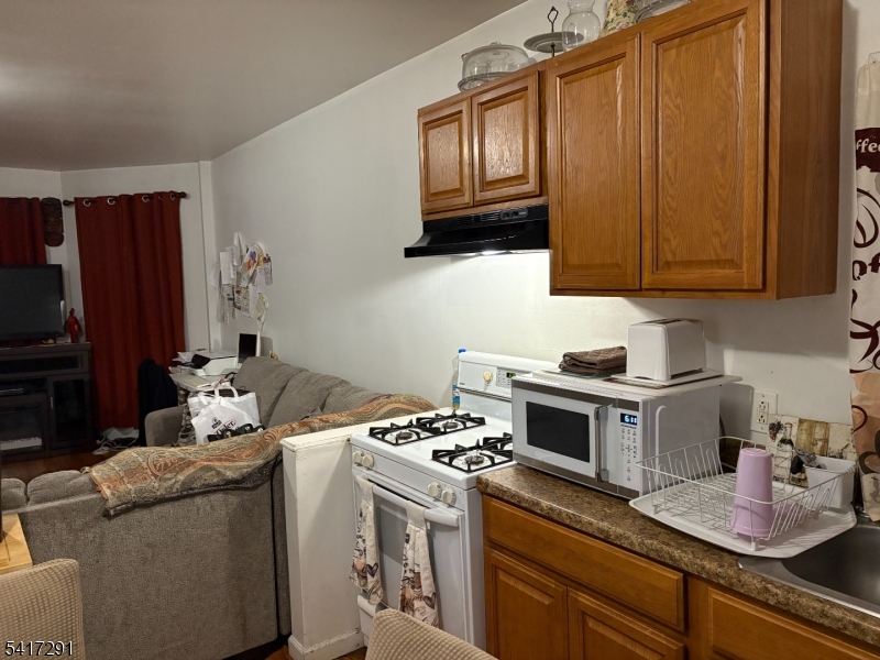 112 4th Avenue Paterson, NJ 07524 - Photo 5 of 20 a kitchen with stainless steel appliances granite countertop a stove and a refrigerator