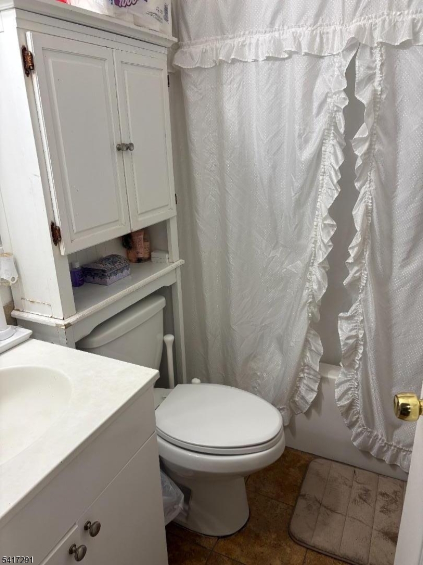112 4th Avenue Paterson, NJ 07524 - Photo 8 of 20 a white toilet sitting next to a shower curtain