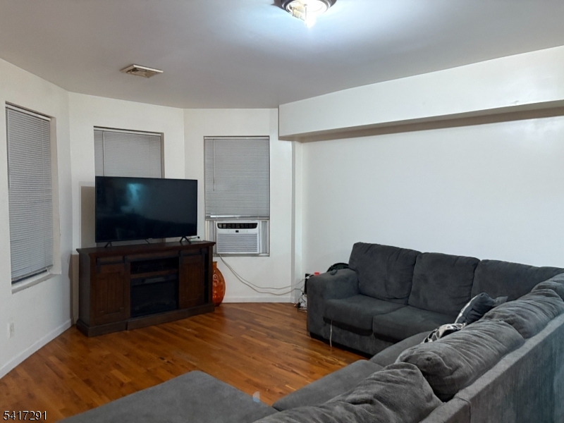 112 4th Avenue Paterson, NJ 07524 - Photo 9 of 20 a living room with furniture and a flat screen tv