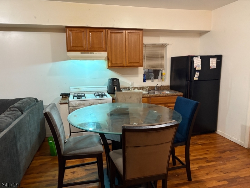 112 4th Avenue Paterson, NJ 07524 - Photo 10 of 20 a dining room with furniture and wooden floor