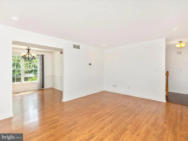 a dining room with furniture a rug and a window
