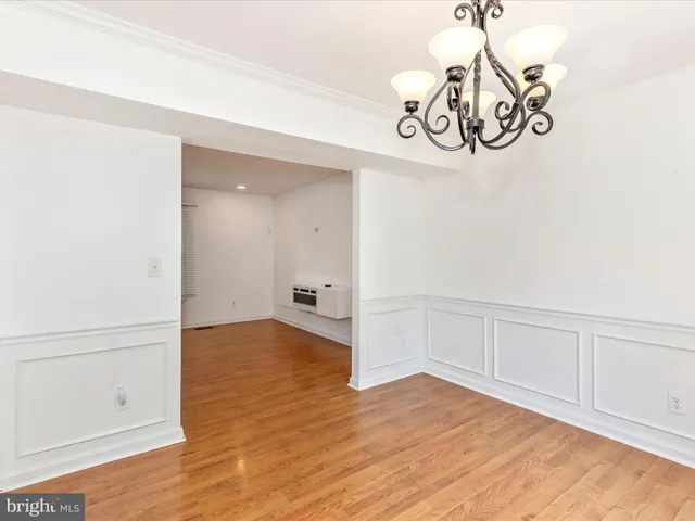 a kitchen with granite countertop stainless steel appliances and wooden floor
