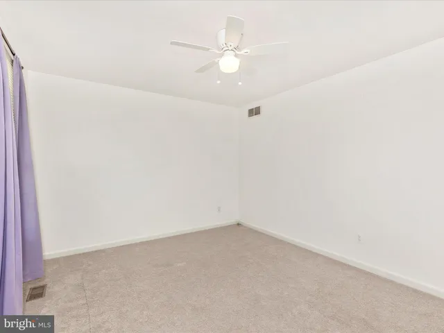 a bathroom with a granite countertop toilet sink and mirror