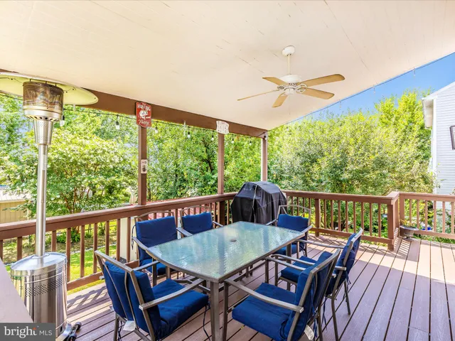 a view of a house with potted plants and a table and chairs
