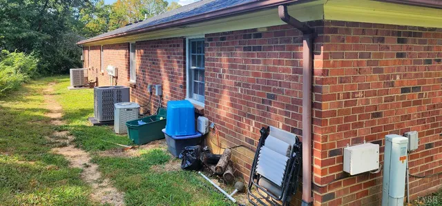 a view of a roof deck with wooden fence and plants