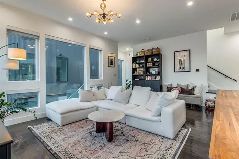 a living room with furniture a rug and a chandelier