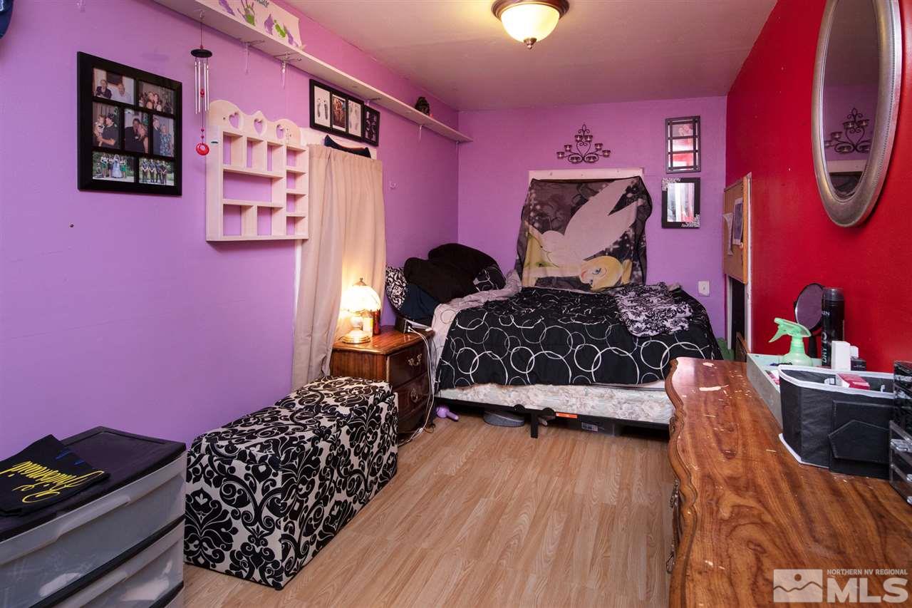 710 Balzar Circle Reno, NV 89502 - Photo 19 of 23 a bedroom with a bed and a chair with the bookshelf