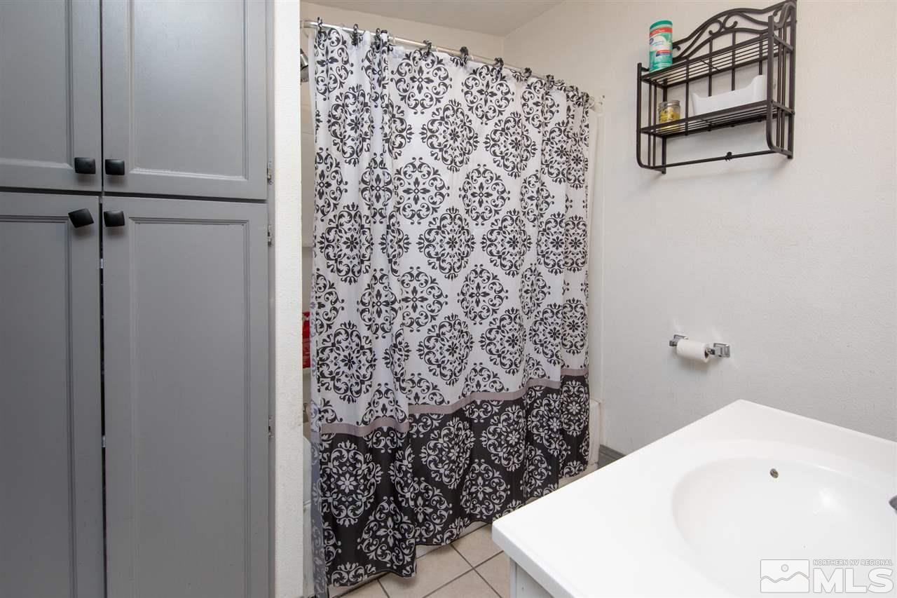 710 Balzar Circle Reno, NV 89502 - Photo 10 of 23 a bathroom with a shower curtain and a sink