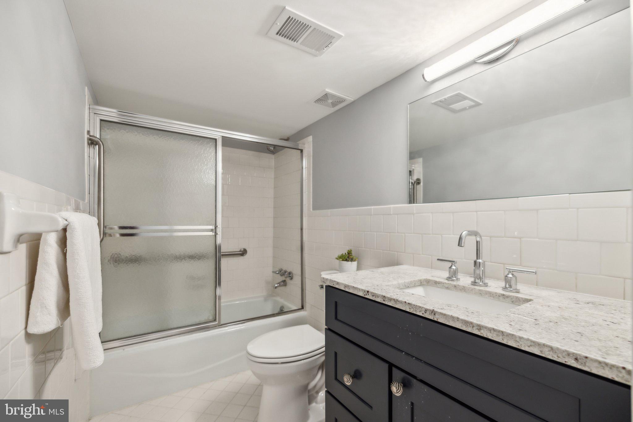 2811 21st Road South Arlington, VA 22206 - Photo 39 of 49 a bathroom with a granite countertop sink toilet and shower