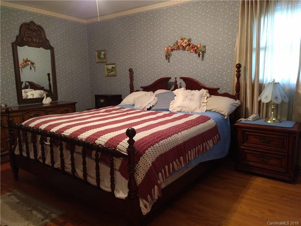 2703 Pearidge Road Bostic, NC 28018 - Photo 14 of 29 a bedroom with a bed a dresser and painting on the wall