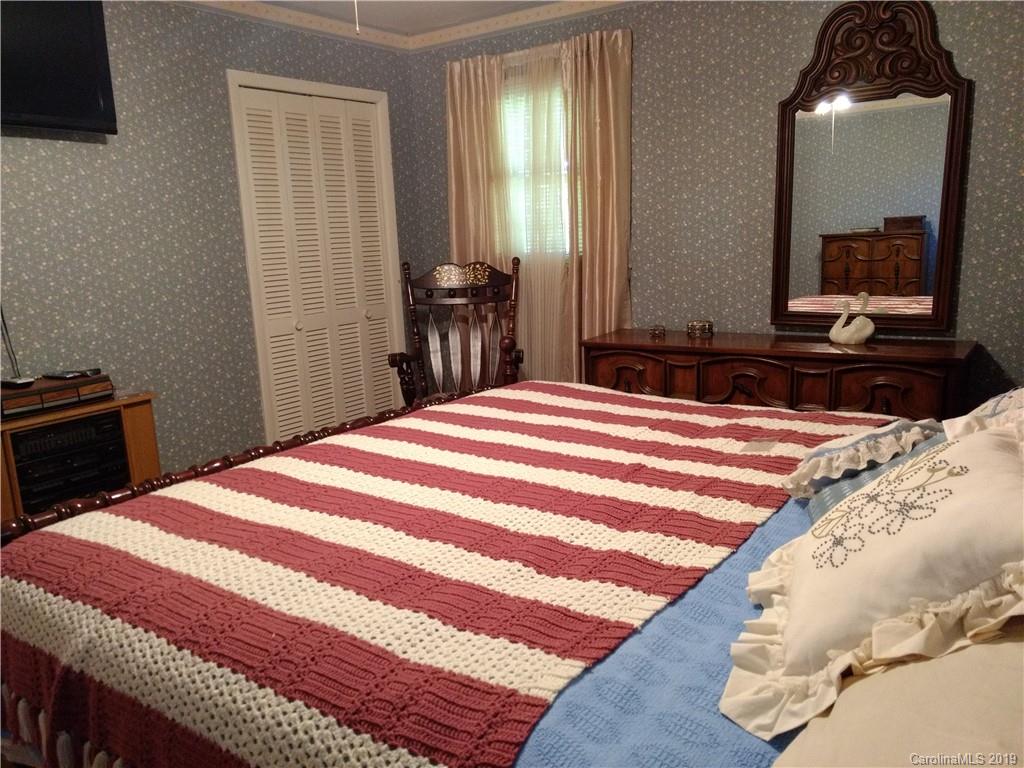 2703 Pearidge Road Bostic, NC 28018 - Photo 17 of 29 a bedroom with a bed and a mirror on dresser