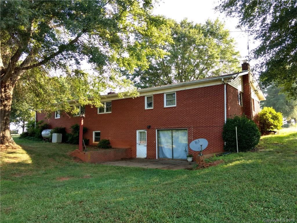 2703 Pearidge Road Bostic, NC 28018 - Photo 27 of 29 a view of a backyard with table and chairs and a large tree