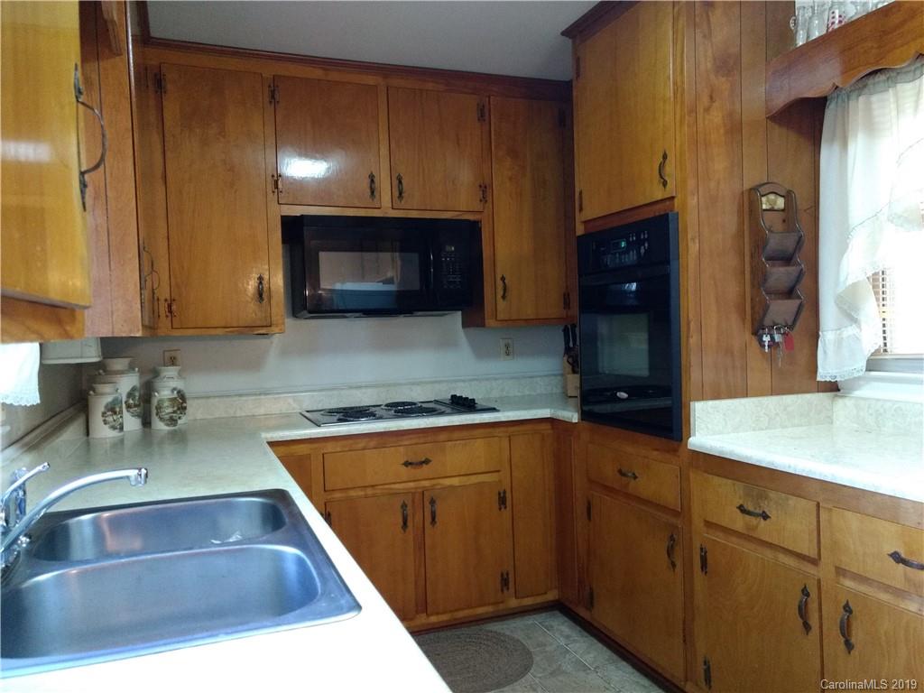 2703 Pearidge Road Bostic, NC 28018 - Photo 4 of 29 a kitchen with kitchen island granite countertop a sink stainless steel appliances and cabinets