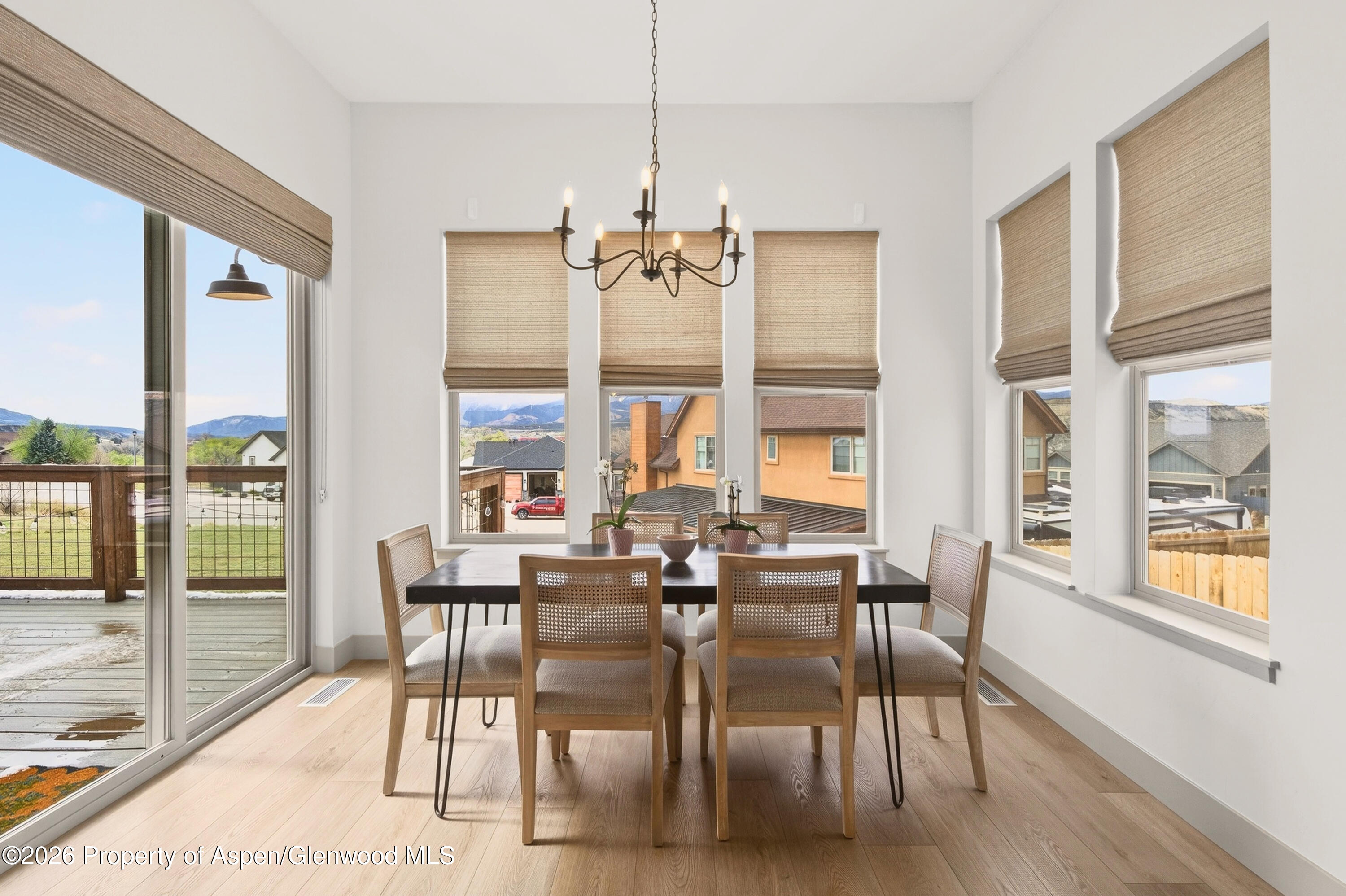 1395 Rifle Heights Drive Rifle, CO 81650 - Photo 11 of 35 a view of a dining room with furniture window and wooden floor