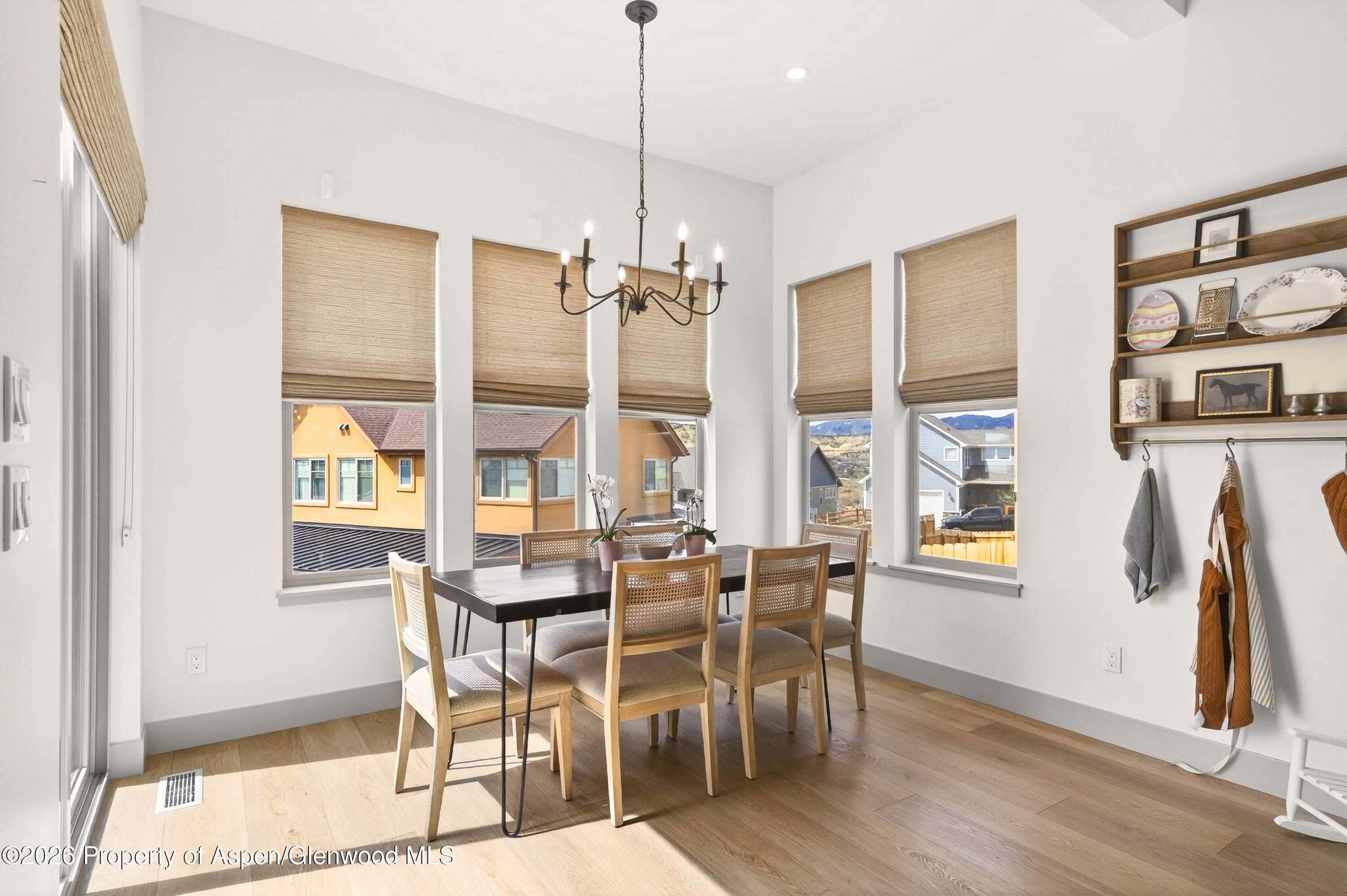 1395 Rifle Heights Drive Rifle, CO 81650 - Photo 12 of 35 a view of a dining room with furniture window and wooden floor
