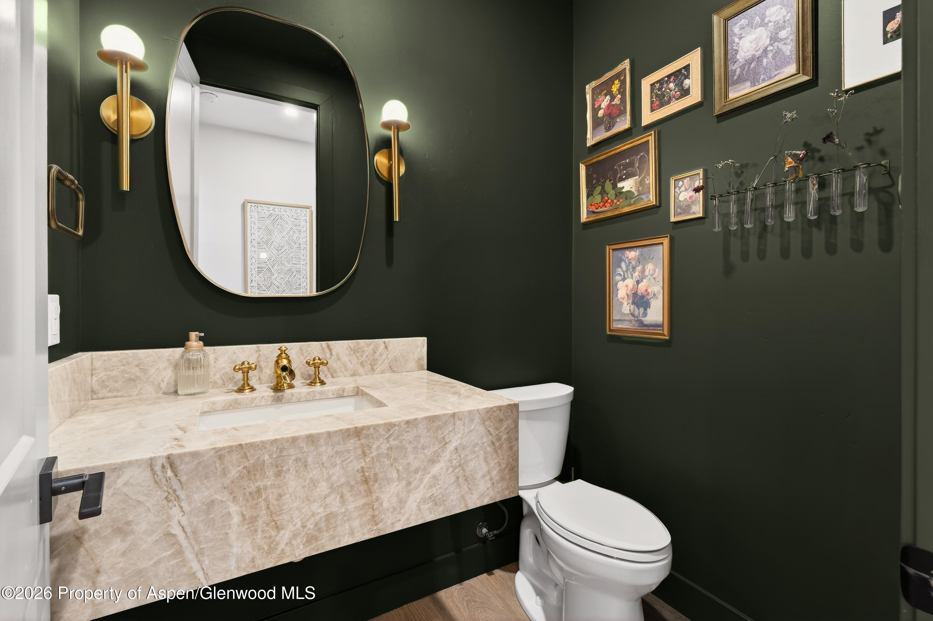 1395 Rifle Heights Drive Rifle, CO 81650 - Photo 18 of 35 a bathroom with a toilet a sink and mirror