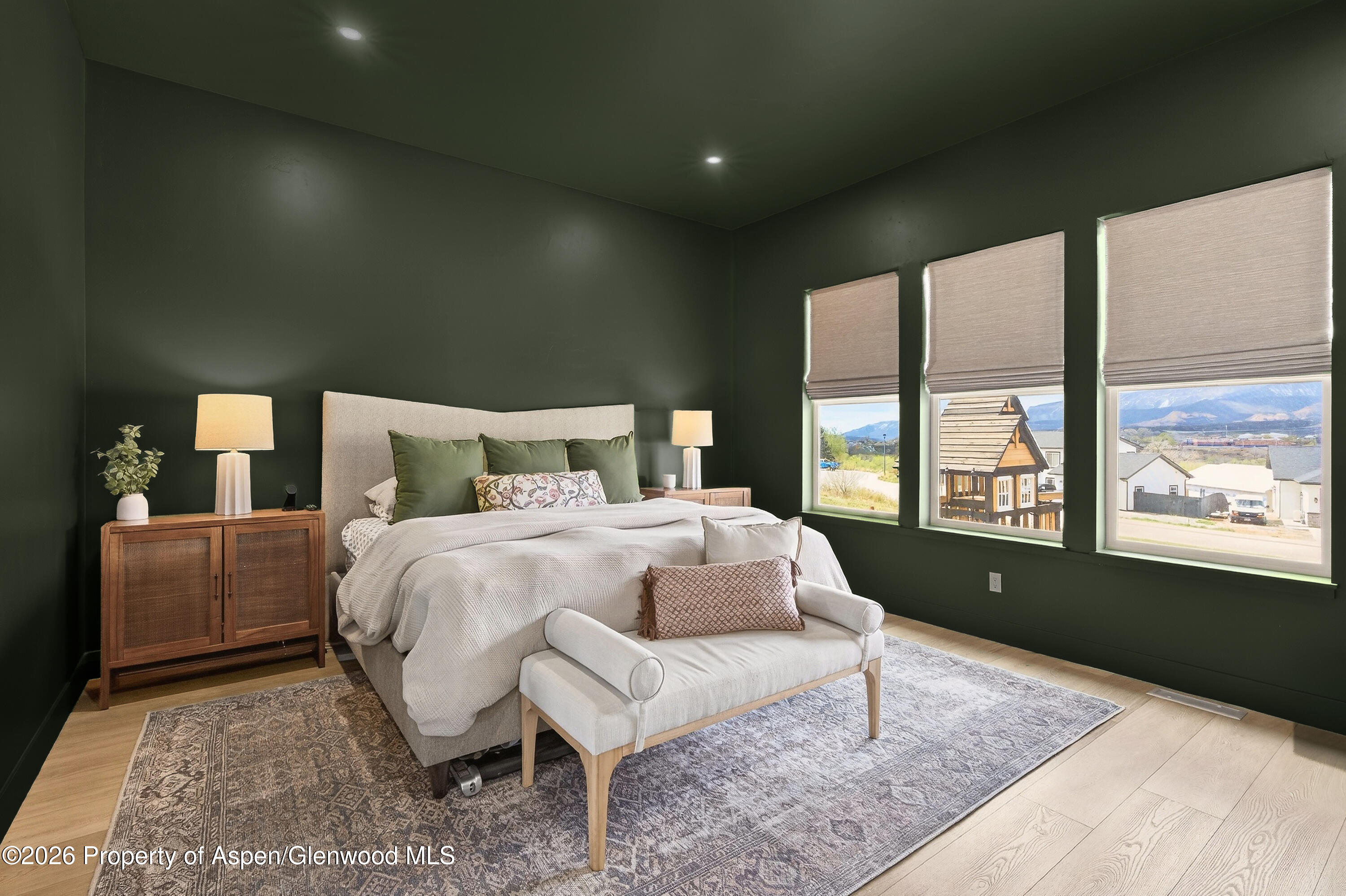 1395 Rifle Heights Drive Rifle, CO 81650 - Photo 19 of 35 a bedroom with a bed and large window