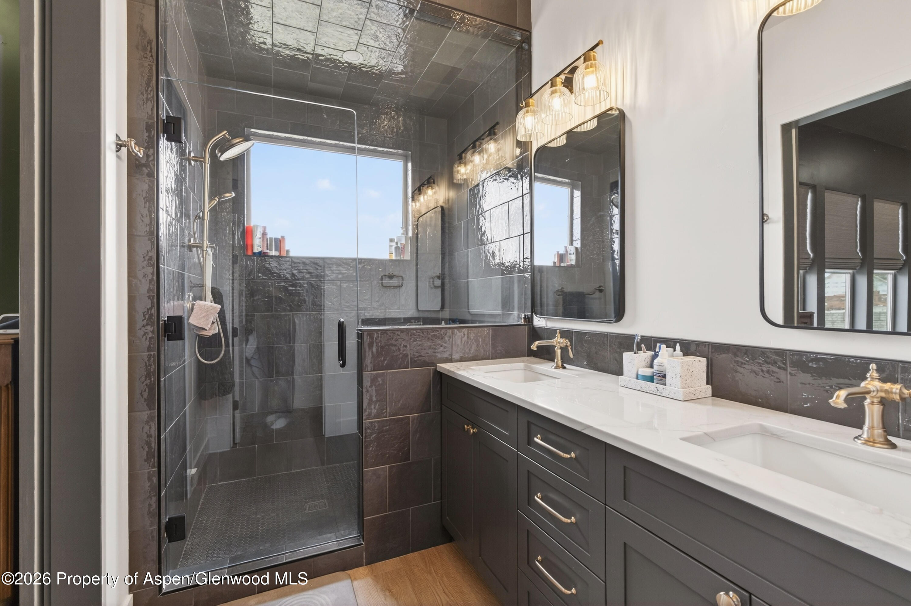 1395 Rifle Heights Drive Rifle, CO 81650 - Photo 20 of 35 a bathroom with a shower sink and mirror