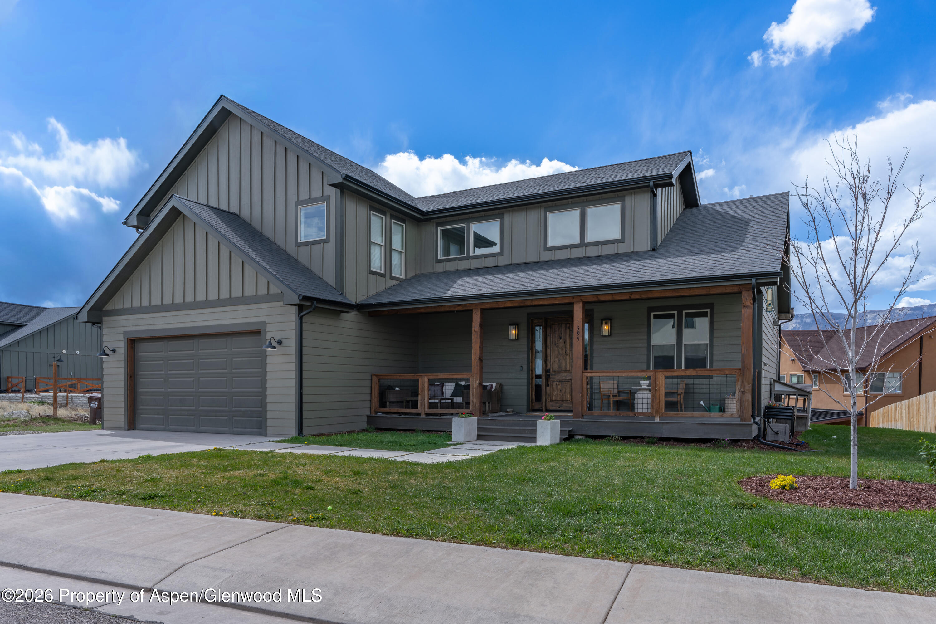 1395 Rifle Heights Drive Rifle, CO 81650 - Photo 29 of 35 a front view of a house with a garden and plants
