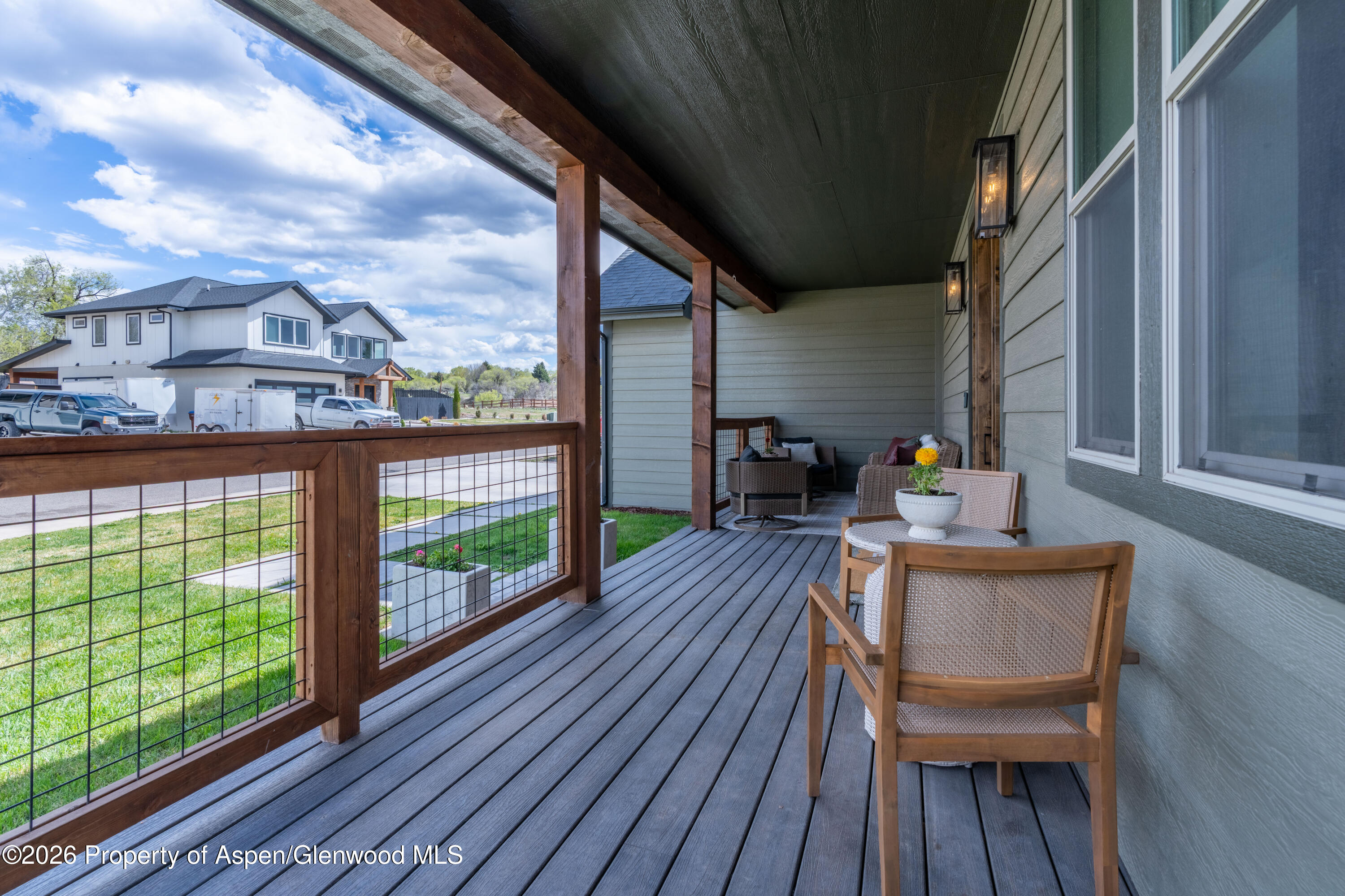 1395 Rifle Heights Drive Rifle, CO 81650 - Photo 34 of 35 a balcony with wooden floor table and chairs