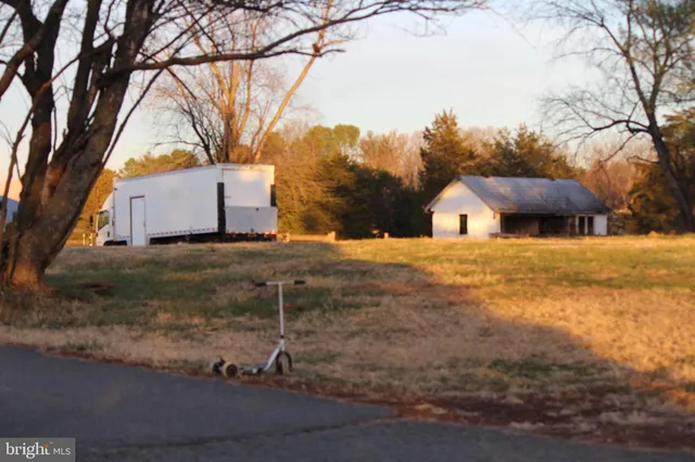 a view of a house with snow on the background