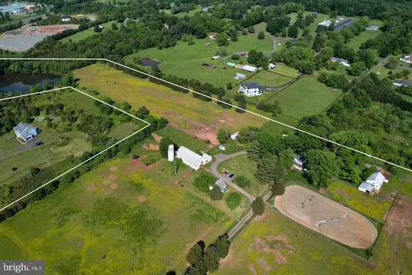an aerial view of a residential houses with outdoor space and river view