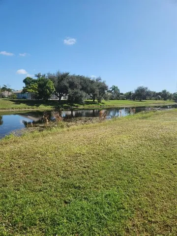 a view of a lake with houses in the back