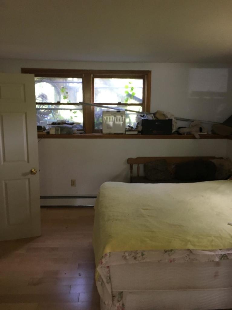 7 Quaker Road Hyannis, MA 02601 - Photo 19 of 20 a bed sitting in a kitchen next to a window