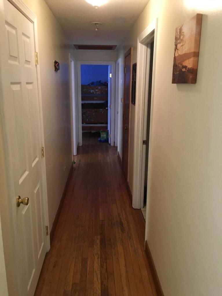7 Quaker Road Hyannis, MA 02601 - Photo 8 of 20 a view of a hallway with wooden floor and staircase