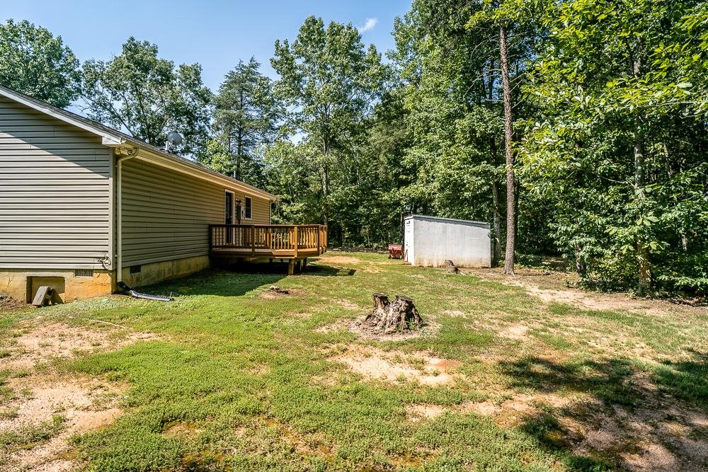 1139 Johnson Road Mineral, VA 23117 - Photo 32 of 33 a backyard of a house with a yard and garage