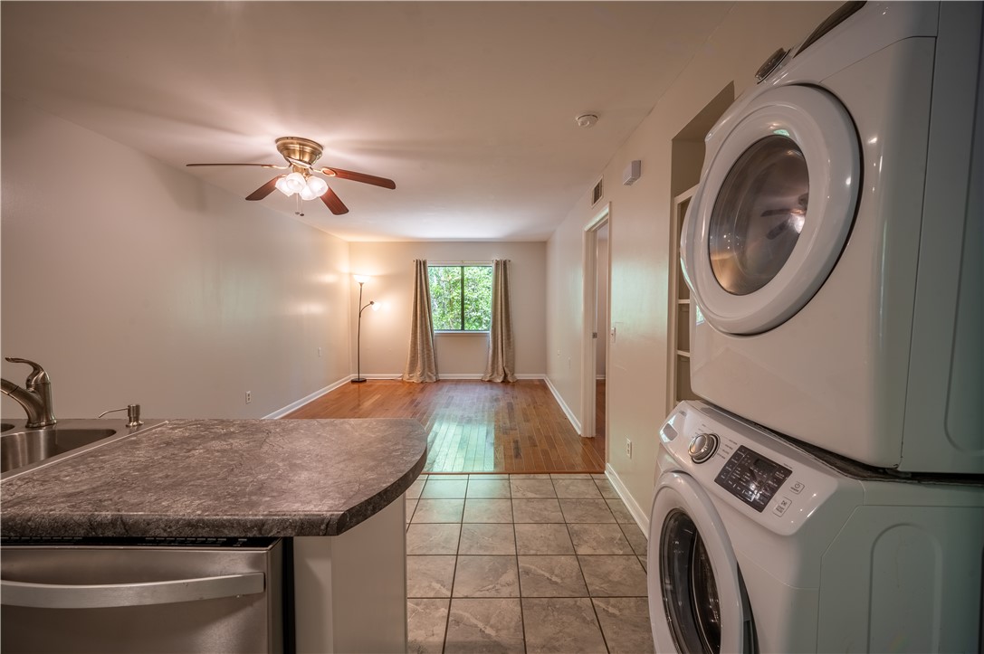 150 Ligon Street, Unit 2302 Clemson, SC 29631 - Photo 2 of 18 This inviting space combines practicality and comfort, featuring a compact laundry area within an open-concept living space.