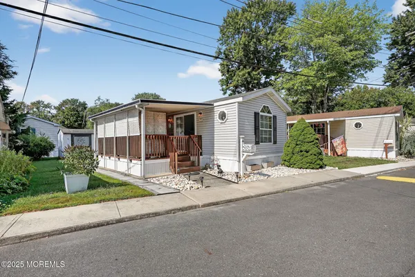 a front view of a house with a garden and plants