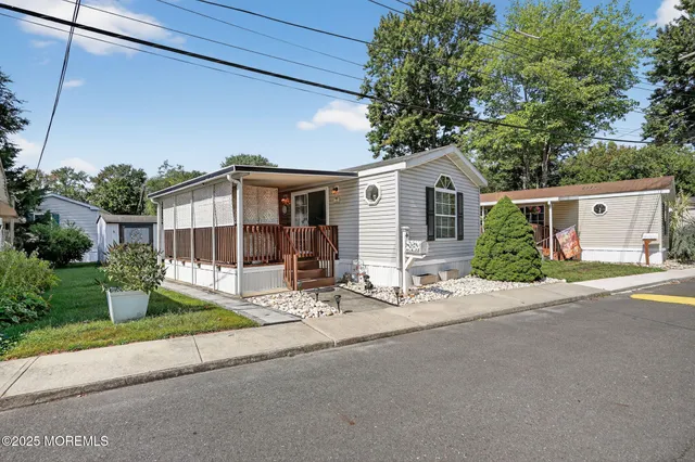 a front view of a house with a garden and plants