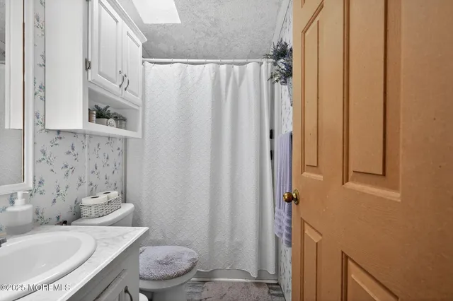 a bathroom with a sink and a washer dryer
