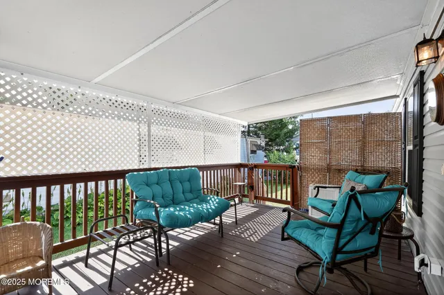 a view of a chairs and table in the balcony