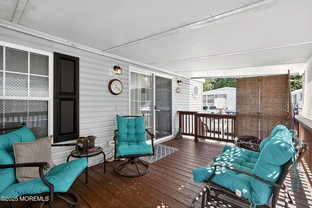a living room with stainless steel appliances furniture and a chandelier