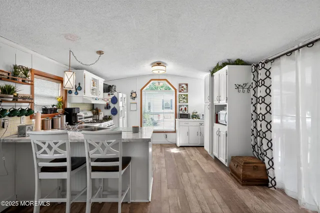 a kitchen with white cabinets and white appliances