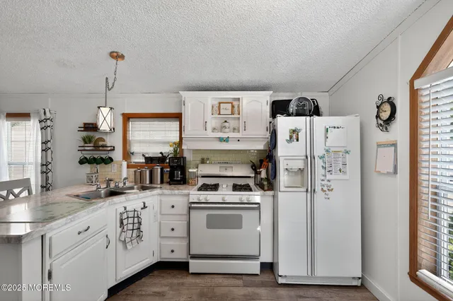 a kitchen with cabinets a sink and appliances