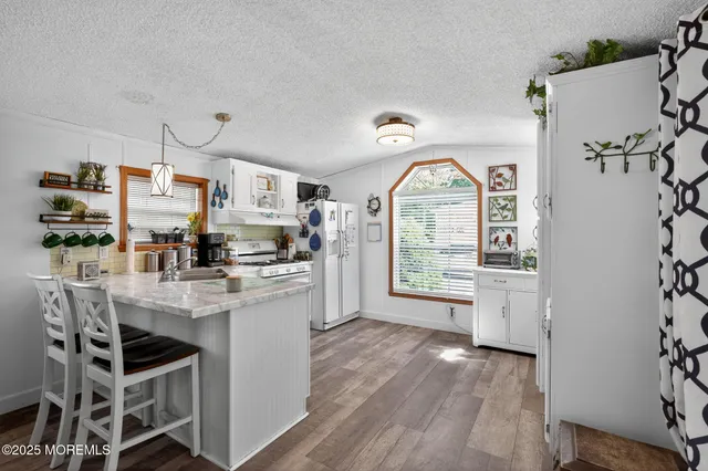 a kitchen with stainless steel appliances a sink stove and cabinets