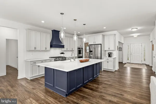 a kitchen with granite countertop white cabinets and oven